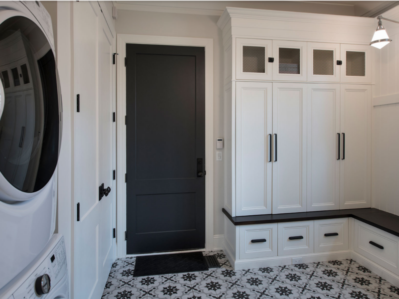 Tricon black painter interior door in a space with mostly white room with black and white tiles.
